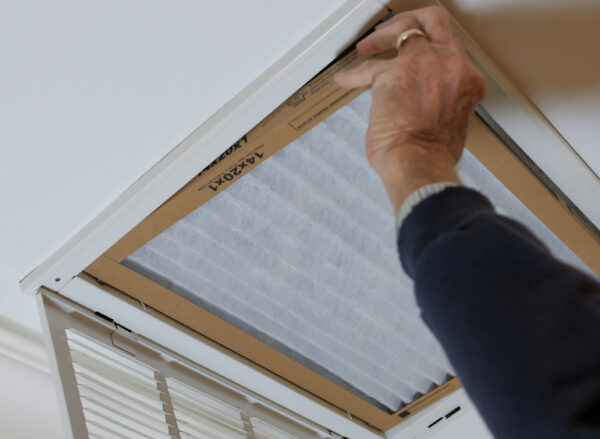 Man,Replacing,Dirty,Hvac,Air,Filter,In,Ceiling,Vent.,Home